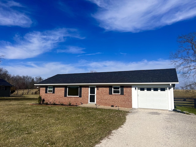 ranch-style house featuring a front yard, gravel driveway, an attached garage, a shingled roof, and brick siding