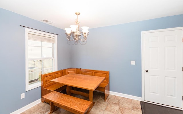 dining room with visible vents, an inviting chandelier, and baseboards