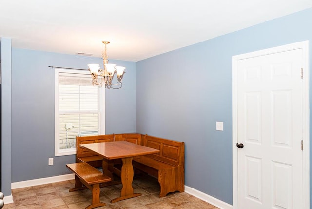 dining room with visible vents, baseboards, and a chandelier