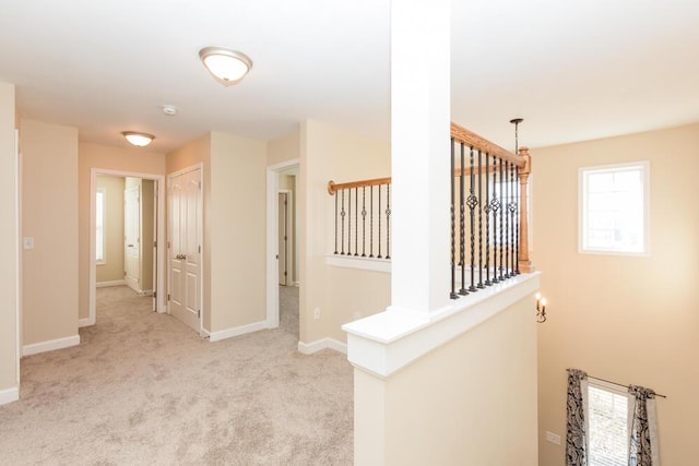 hall with baseboards and carpet flooring