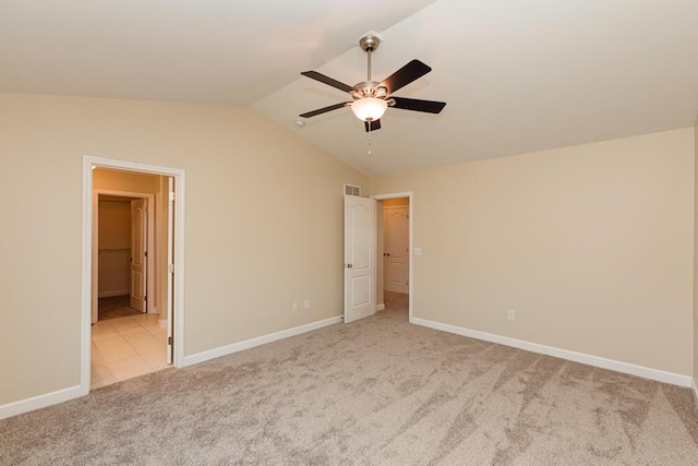 unfurnished bedroom with lofted ceiling, carpet flooring, baseboards, and visible vents