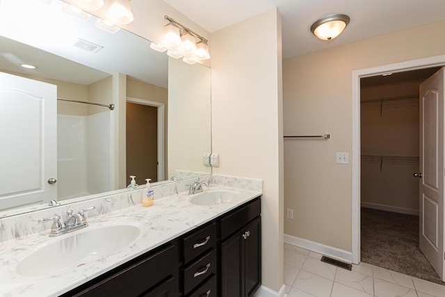 full bath with visible vents, baseboards, and a sink