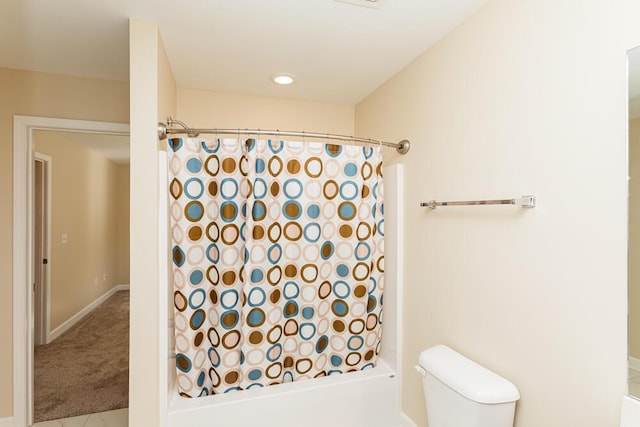 bathroom with toilet, visible vents, and shower / tub combo with curtain