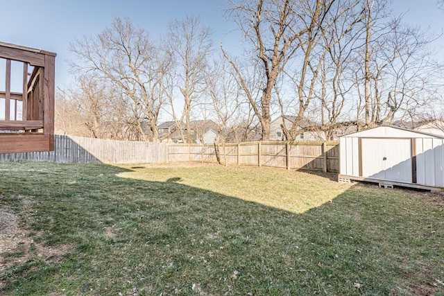 view of yard featuring a fenced backyard, a storage shed, and an outdoor structure