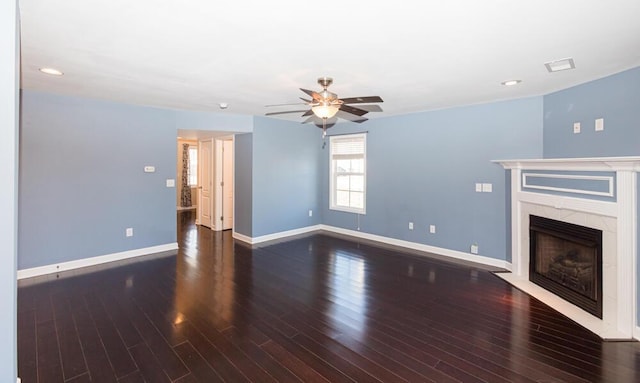 unfurnished living room featuring baseboards, wood finished floors, a ceiling fan, and a tile fireplace