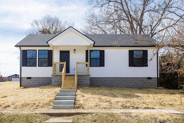 bungalow-style home featuring crawl space and roof with shingles