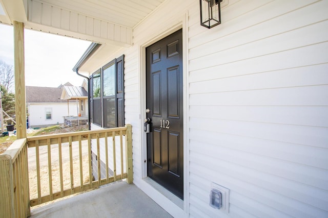 view of exterior entry with covered porch