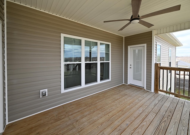 wooden terrace featuring a ceiling fan