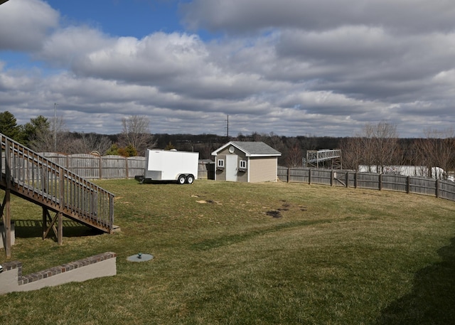 view of yard featuring an outbuilding and a fenced backyard