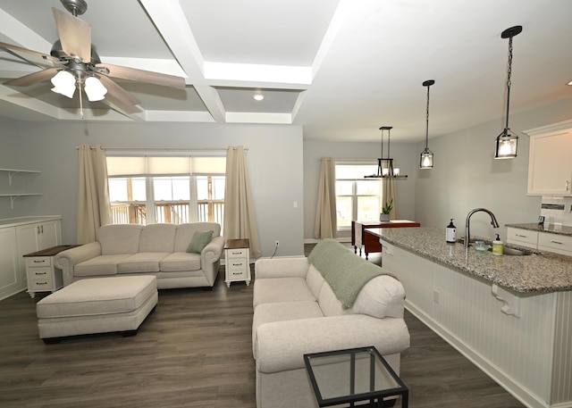 living room featuring beam ceiling, a ceiling fan, coffered ceiling, dark wood-style floors, and recessed lighting