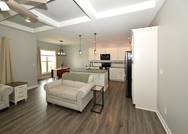 living area featuring coffered ceiling, baseboards, and dark wood-style flooring