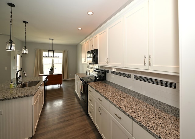 kitchen with tasteful backsplash, dark wood-style floors, white cabinets, black appliances, and a sink