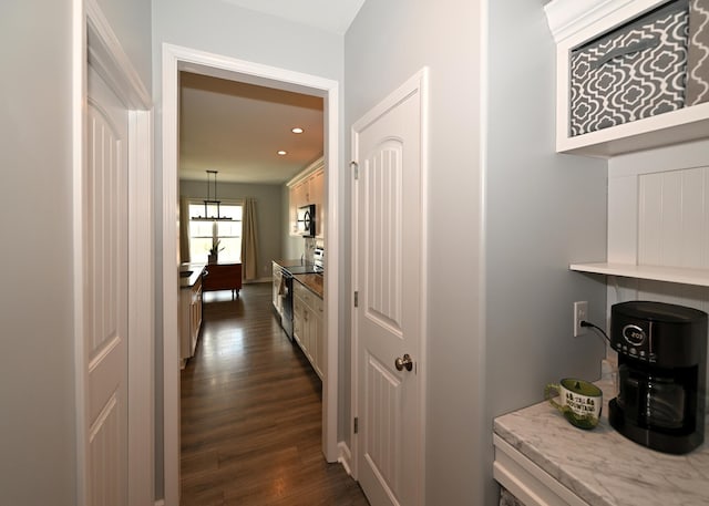 hallway featuring recessed lighting and dark wood-type flooring