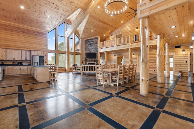 dining space featuring a notable chandelier, recessed lighting, wooden ceiling, and a stone fireplace