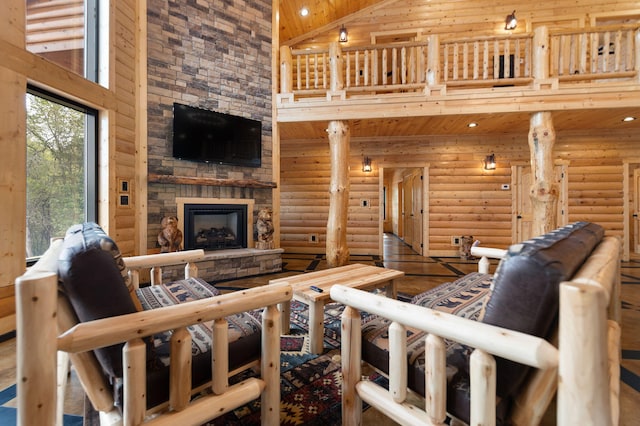 living room featuring high vaulted ceiling, wood finished floors, recessed lighting, a fireplace, and log walls