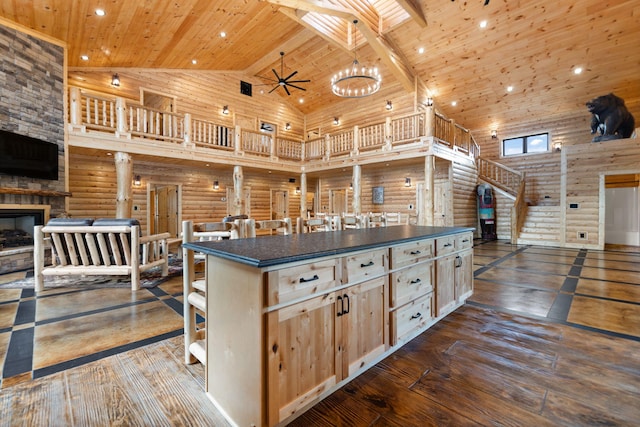 kitchen with dark countertops, dark wood-style floors, high vaulted ceiling, and wood ceiling
