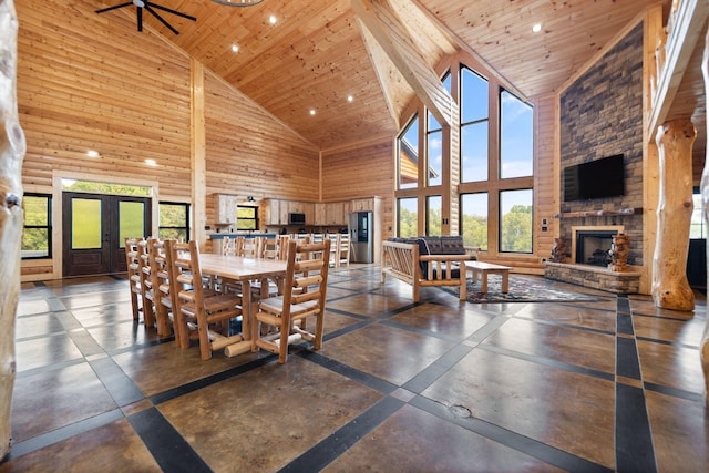 dining space with a stone fireplace, recessed lighting, wood ceiling, and high vaulted ceiling