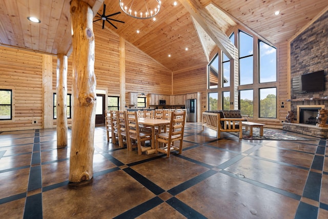dining area featuring a stone fireplace, recessed lighting, and wooden ceiling