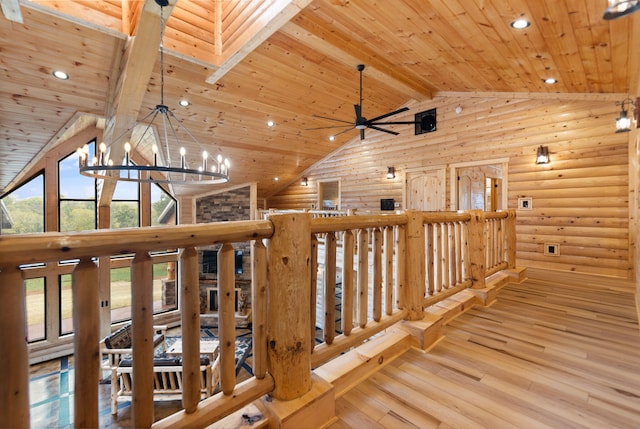 hall featuring beamed ceiling, wood finished floors, rustic walls, wooden ceiling, and a chandelier