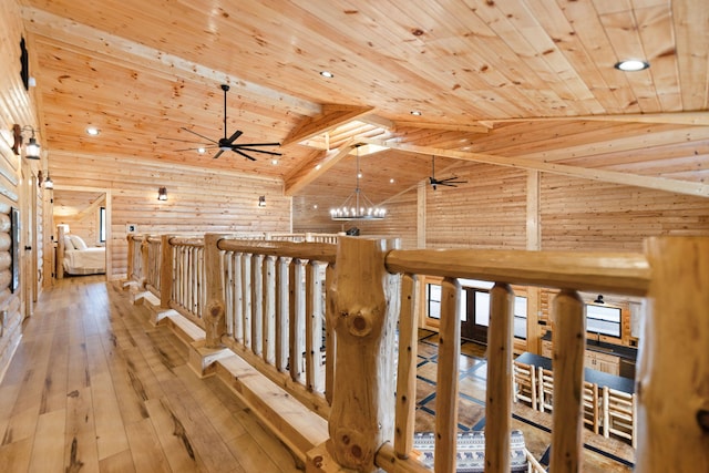 corridor with beamed ceiling, hardwood / wood-style floors, wooden ceiling, rustic walls, and high vaulted ceiling
