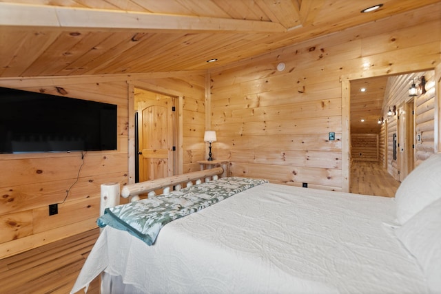 bedroom with wooden ceiling, wood finished floors, and wood walls