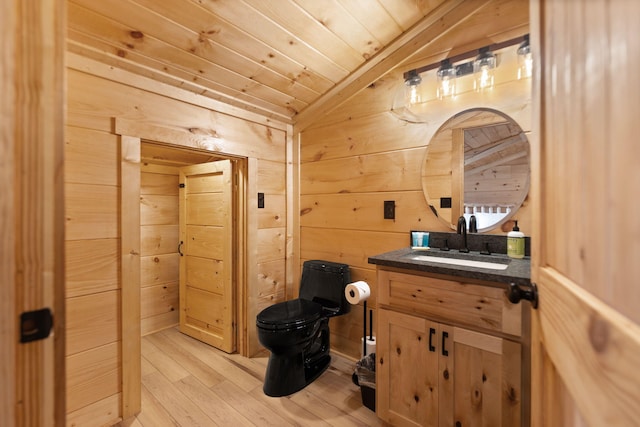 bathroom with wood walls, wood ceiling, toilet, vaulted ceiling, and wood finished floors