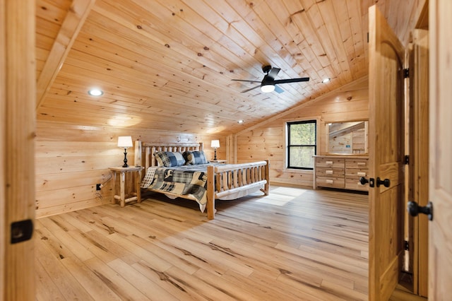 bedroom featuring vaulted ceiling, wooden walls, wooden ceiling, and wood finished floors