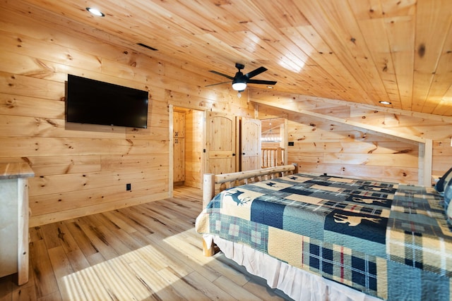 bedroom featuring lofted ceiling, wood ceiling, wood finished floors, and wood walls