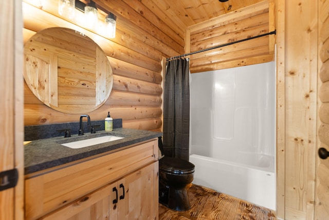 bathroom with vanity, wood finished floors, shower / bathtub combination with curtain, toilet, and rustic walls