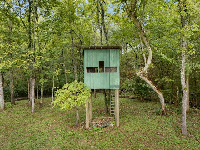 view of outdoor structure with a view of trees