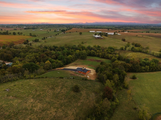 aerial view at dusk featuring a rural view