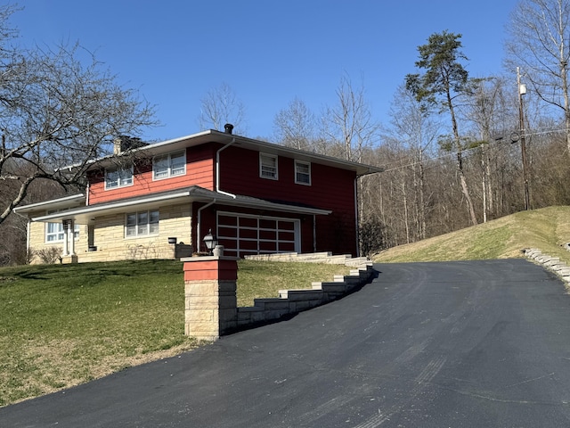 view of front of home featuring stone siding and a front yard