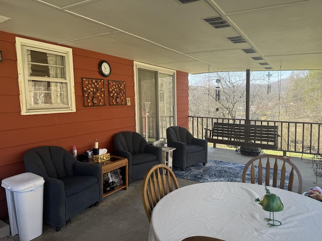 exterior space featuring visible vents, wooden walls, and floor to ceiling windows