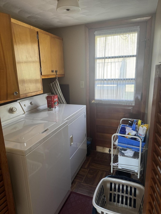 washroom with cabinet space and washing machine and dryer