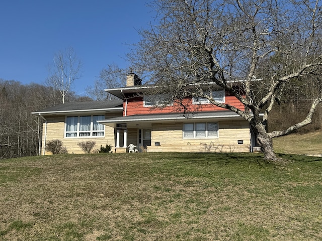 view of front of house with a chimney and a front yard