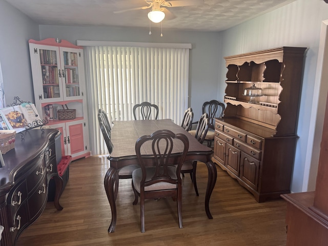 dining space featuring dark wood-style floors and a ceiling fan