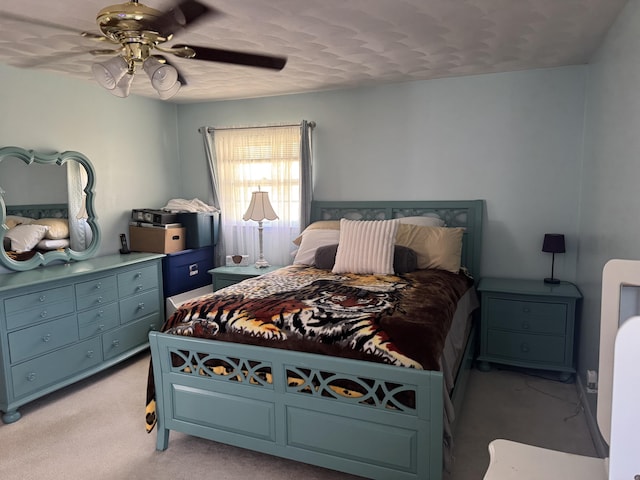 bedroom featuring light carpet and a ceiling fan