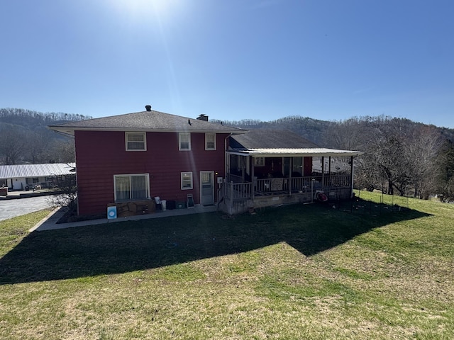 rear view of house featuring a lawn