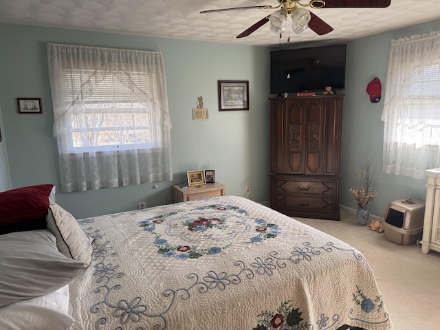 carpeted bedroom with baseboards and ceiling fan