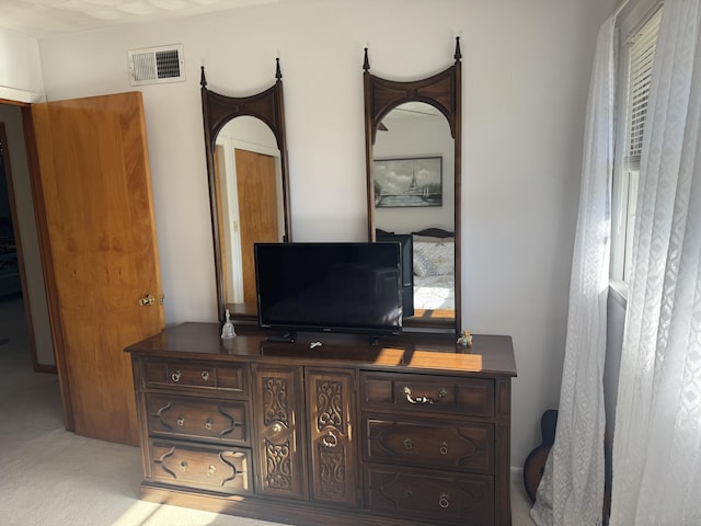 bedroom with visible vents and carpet floors