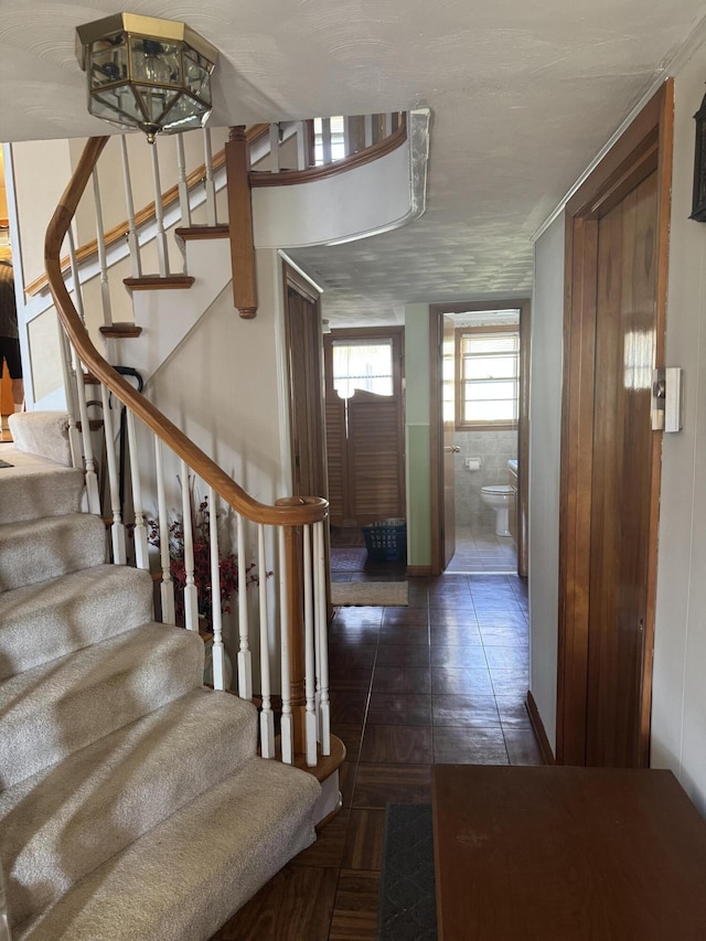 entryway with tile patterned floors and stairway