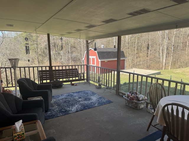 view of patio with a storage unit, visible vents, and an outdoor structure