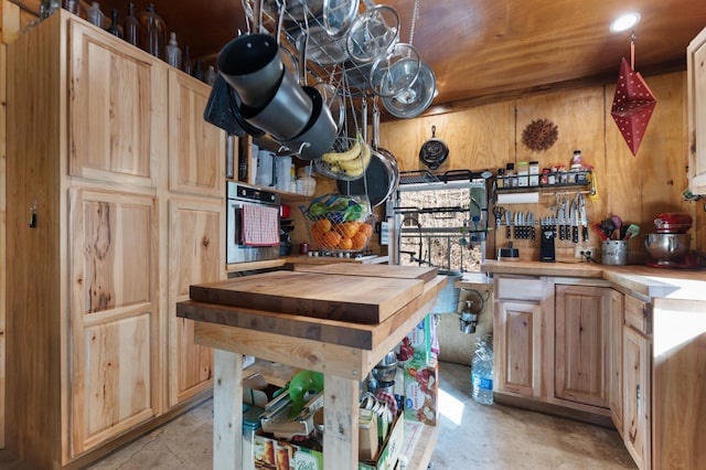3860 Newfound Rd, Oneida, KY 40972 - kitchen featuring wooden counters, stainless steel oven, light brown cabinetry, wooden walls, and concrete flooring