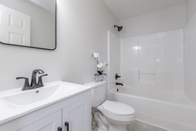 bathroom featuring vanity, toilet, and shower / bathtub combination