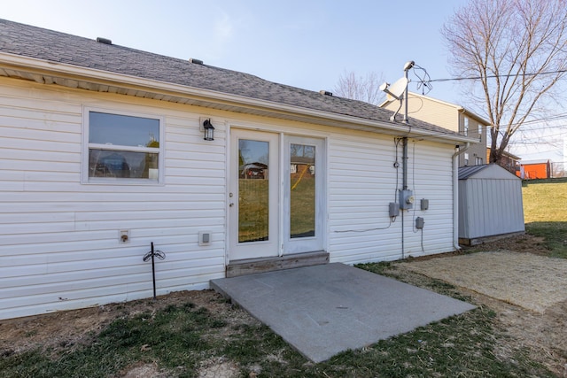 back of house with roof with shingles