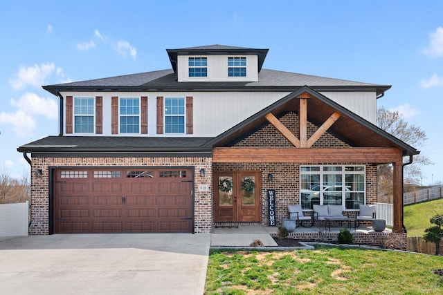 view of front facade featuring fence, driveway, an attached garage, french doors, and brick siding