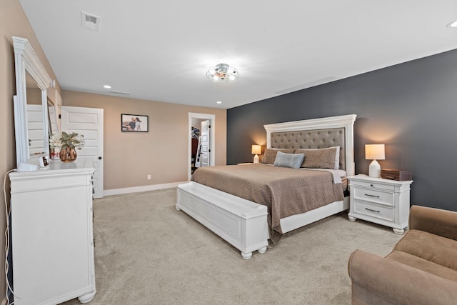 bedroom featuring a spacious closet, visible vents, baseboards, light carpet, and recessed lighting