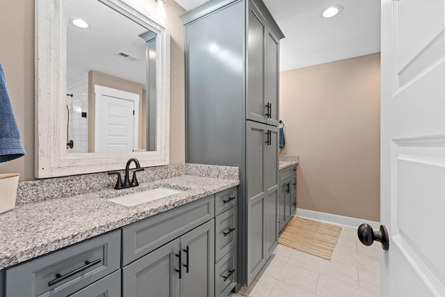 bathroom featuring vanity, visible vents, recessed lighting, and baseboards