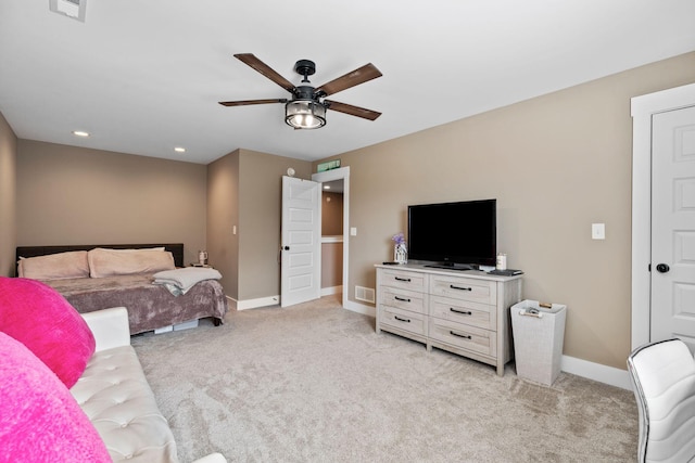 bedroom featuring light carpet, visible vents, a ceiling fan, and baseboards