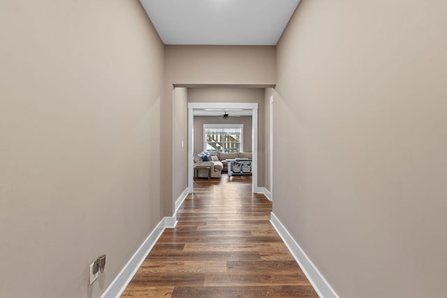 hall with dark wood finished floors and baseboards